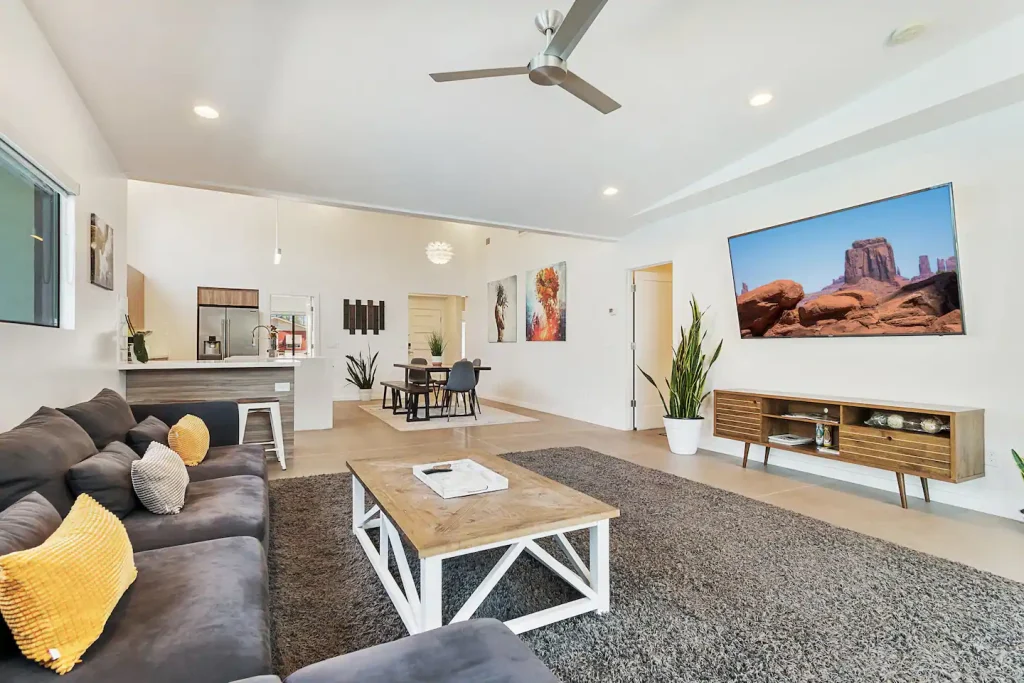 The living room with a large television and a coffee table